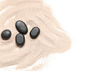 Light beach sand with lines and black pebbles on white background