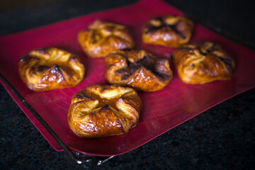 fresh baked filled puff pastry on a silicon mat, to coffee time a homemade sweet pastry