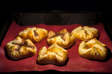 fresh baked filled puff pastry on a silicon mat, to coffee time a homemade sweet pastry