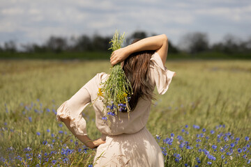 Woman with bouquet of wild herbs for hair care