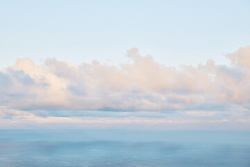 Soft Pastel Clouds Over the Ocean at Horizon