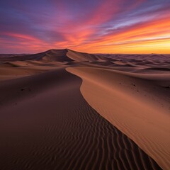  Stunning desert dunes are illuminated by the warm tones of sunset, showcasing the raw patterns of wind-sculpted sand.