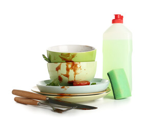 Many dirty dishes with cutlery, detergent and sponge isolated on white background
