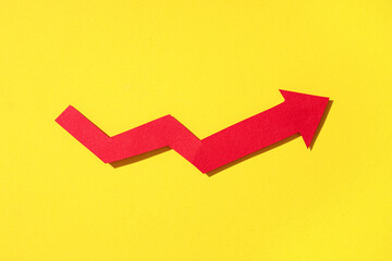 Red arrow on yellow background. Price rise concept