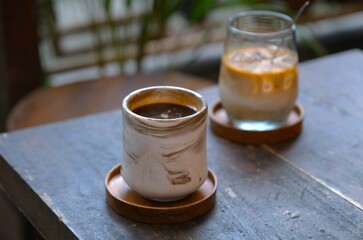 Various kind of coffee drink on the table. A cup of hot americano coffee an a glass of iced coffee...