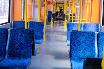 Modern public transport, offering comfortable urban travel, Spacious tram cabin with vibrant blue...
