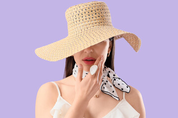Stylish young woman in summer hat on lilac background, closeup