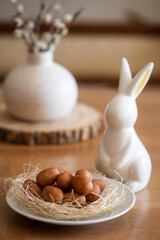Marzipan eggs and an Easter bunny on the table - decoration and traditional German sweets for the holiday.