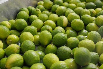 Fresh Green Limes Washed in Water Close Up Citrus Fruit for Food Industry and Healthy Eating Background
