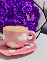 Pink Cloud-Patterned Mug with Coffee and Purple Rose Bouquet