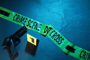Forensic expertise. Crime scene tape and gun on color background, flat lay. Space for text