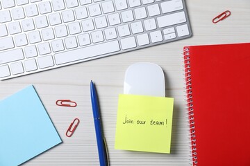 Paper note with phrase Join Our Team, keyboard and stationery on white wooden table, flat lay