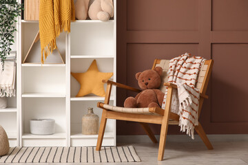 Interior of children's room with shelf unit and armchair