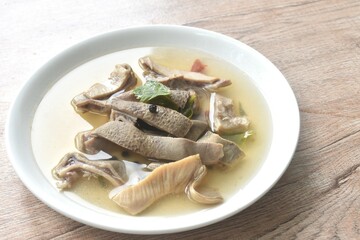 boiled braised slice pork stomuach with black pepper in clear bone soup on plate