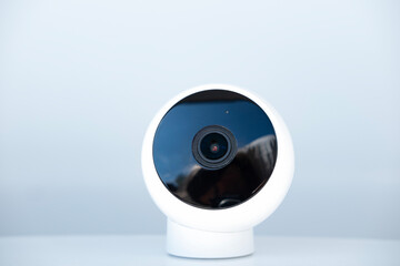 compact, spherical small security camera with sleek design against white background, modern home...