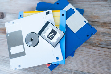 Small 1TB SSD drive held, Professional memory card in stylish packaging on vintage wooden...