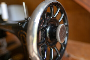Vintage black sewing machine detail, retro craftsmanship, old technology, mechanical parts, historical object, sewing and tailoring
