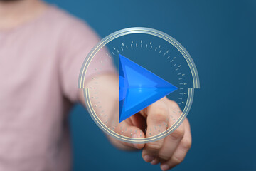 Hand interacting with a futuristic play button.  Concept for digital media, technology, and user...