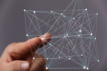 Abstract image of a hand interacting with a digital network, representing connection and data.
