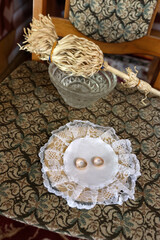 Wedding rings on a tray and holy water. Wedding ring blessing ceremony.