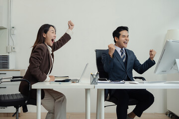 Team businessman are excited business success with inspiration from their excellent financial results that are happy working in a modern office.