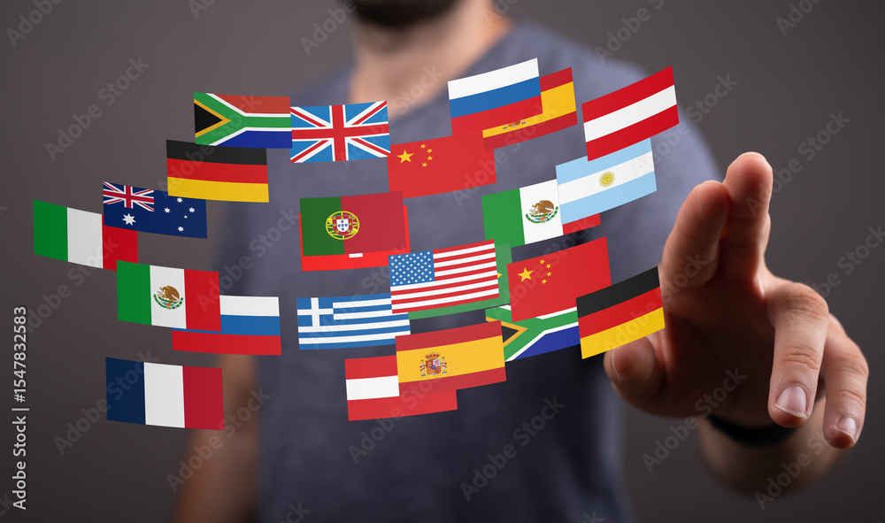 Poster image of a man interacting with a digital display of various national flags, symbolizing global busi