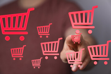 Person interacts with digital shopping carts, showcasing online retail and e-commerce.
