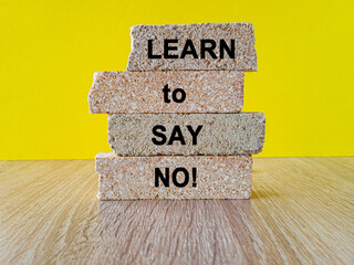 Brick blocks with words phrase Learn to say no on beautiful yellow background. Business...