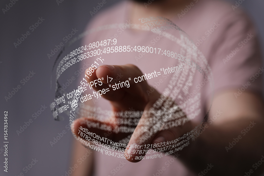 Aufkleber A hand interacts with a digital, holographic display showing lines of code.  Technology concept.