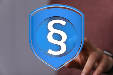 Image of a digital shield protecting a paragraph symbol, representing legal security and online...