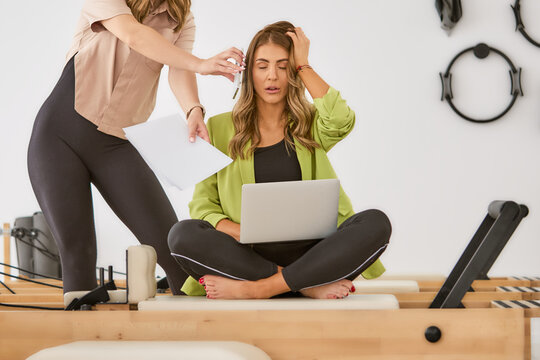 Business woman, overwhelmed and busy with headache, stress and laptop with chaos, project and schedule.