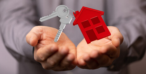 Image of house keys and a red house model in open hands, perfect for real estate, home buying, and...