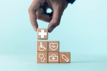 Health insurance concept, access to health benefits, wooden block plus icons for medicine, health care benefits, hospital business and increase in health insurance.