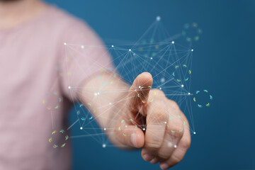 Hand interacting with a digital network, showcasing connection and technology.