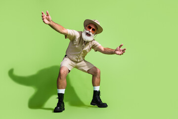 Elderly adventurer in fashionable safari attire ready for new expedition