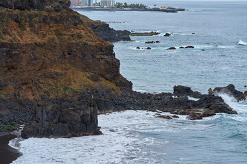 Volcanic coastline and ocean surf