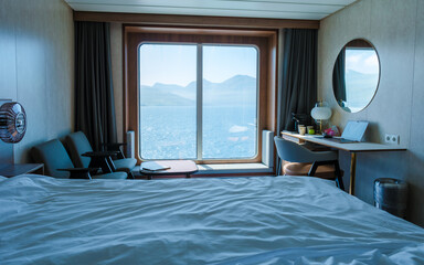 Cozy cruise boat room with stunning views of the Faroe Islands landscape and serene waters