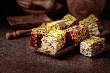 Traditional Turkish delight on an old brown table.