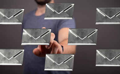 Person interacting with digital emails, choosing one from many.