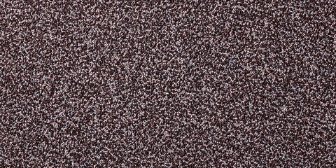 Fototapeta premium Detailed texture of brown speckled carpet surface with close-up view