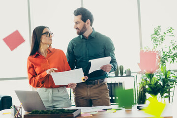 Professional teamwork and collaboration in a modern office workspace with colleagues discussing...