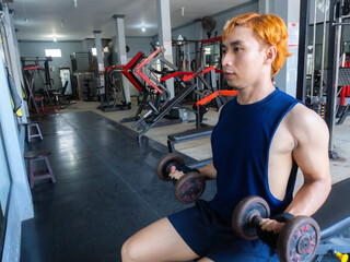 Asian men use gym equipment to do tricep, chest, arm exercises, focusing on building strength and...