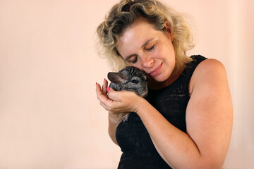 People care for and play with chinchillas.