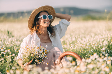 Daisy Woman Flowers: Smiling woman sits in daisy field during daytime holding bouquet.