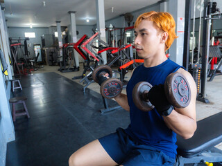 Asian men use gym equipment to do tricep, chest, arm exercises, focusing on building strength and...