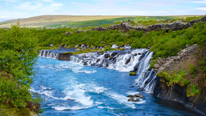 Discover the stunning Barnafoss and Hraunfossar waterfalls in Icelands serene landscape
