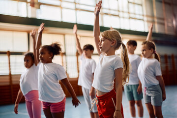 Elementary students warming up on PE class at school.