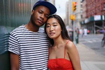 Portrait of Trendy Black Man and Asian Woman Couple on Urban Street