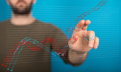 Stock photo of a person interacting with a digital graph showing business growth and decline trends.