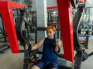 Asian men use gym equipment to do tricep, chest, arm exercises, focusing on building strength and...